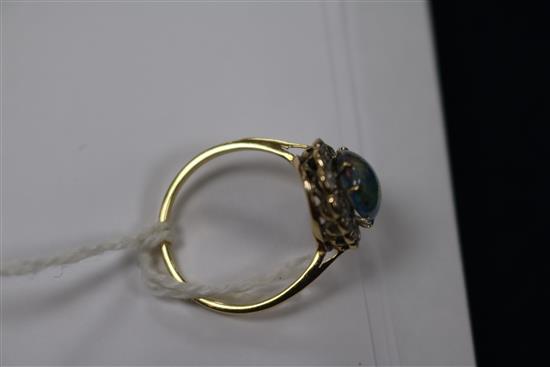 A yellow metal, opal and diamond oval cluster ring, size O.